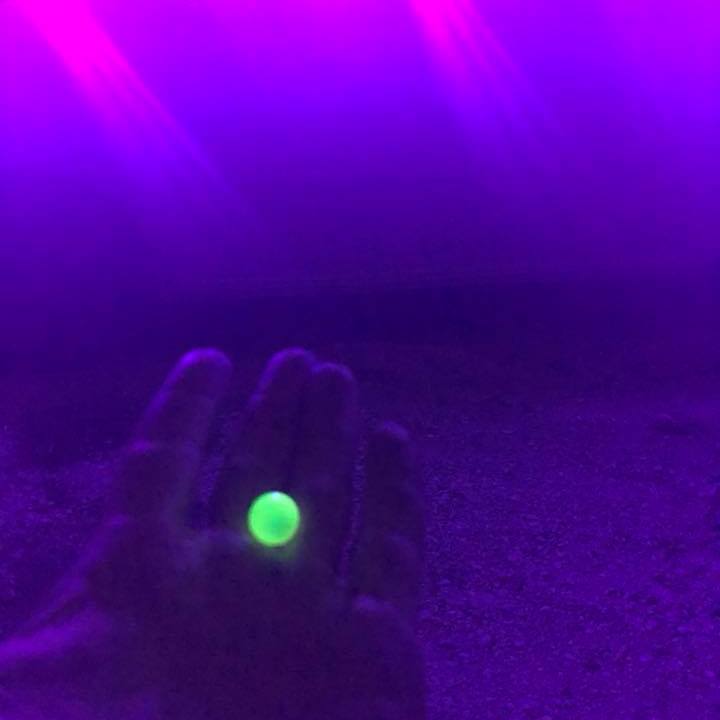 a purple light in front of a stage